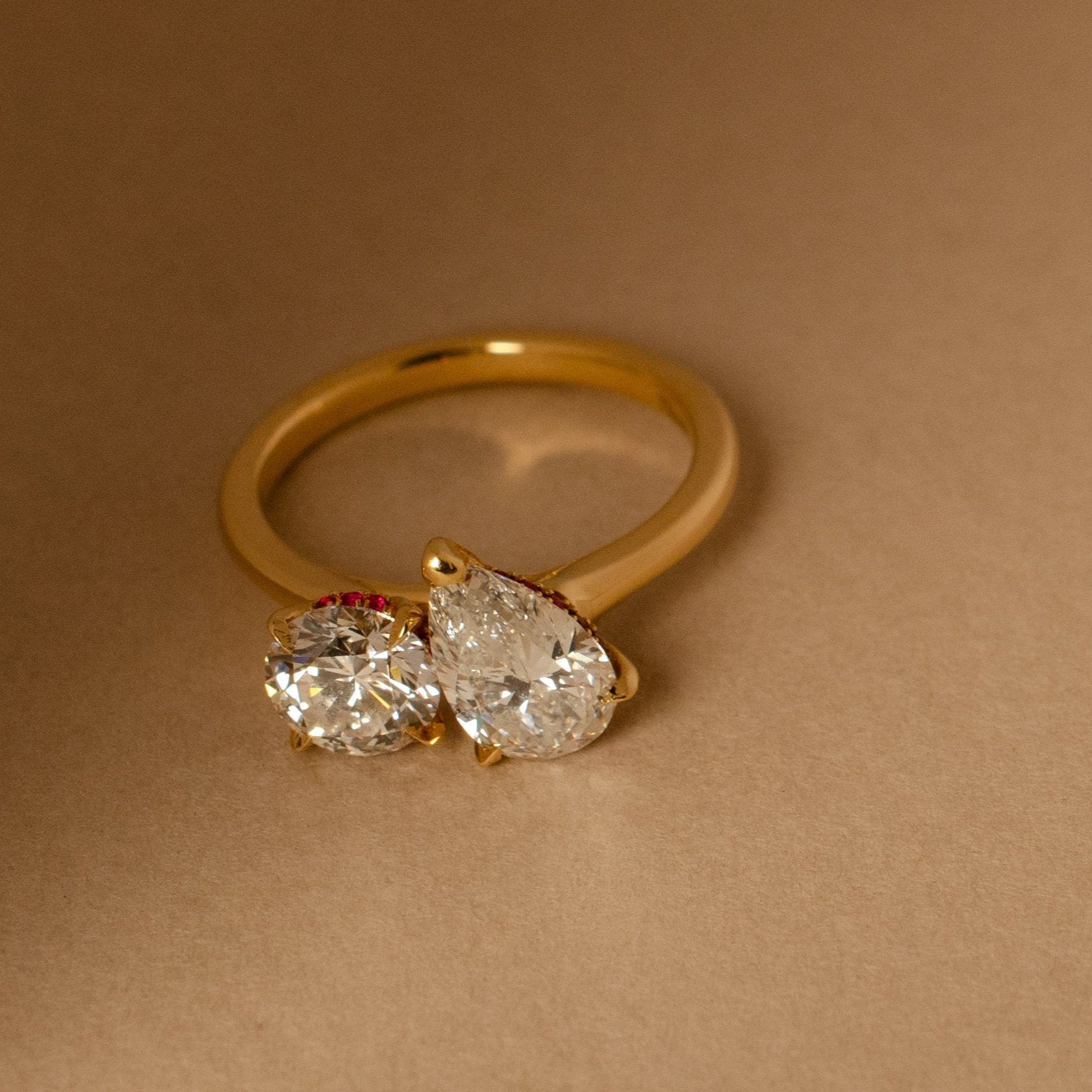 Two Stone Engagement Ring with round cut and pear cut diamonds