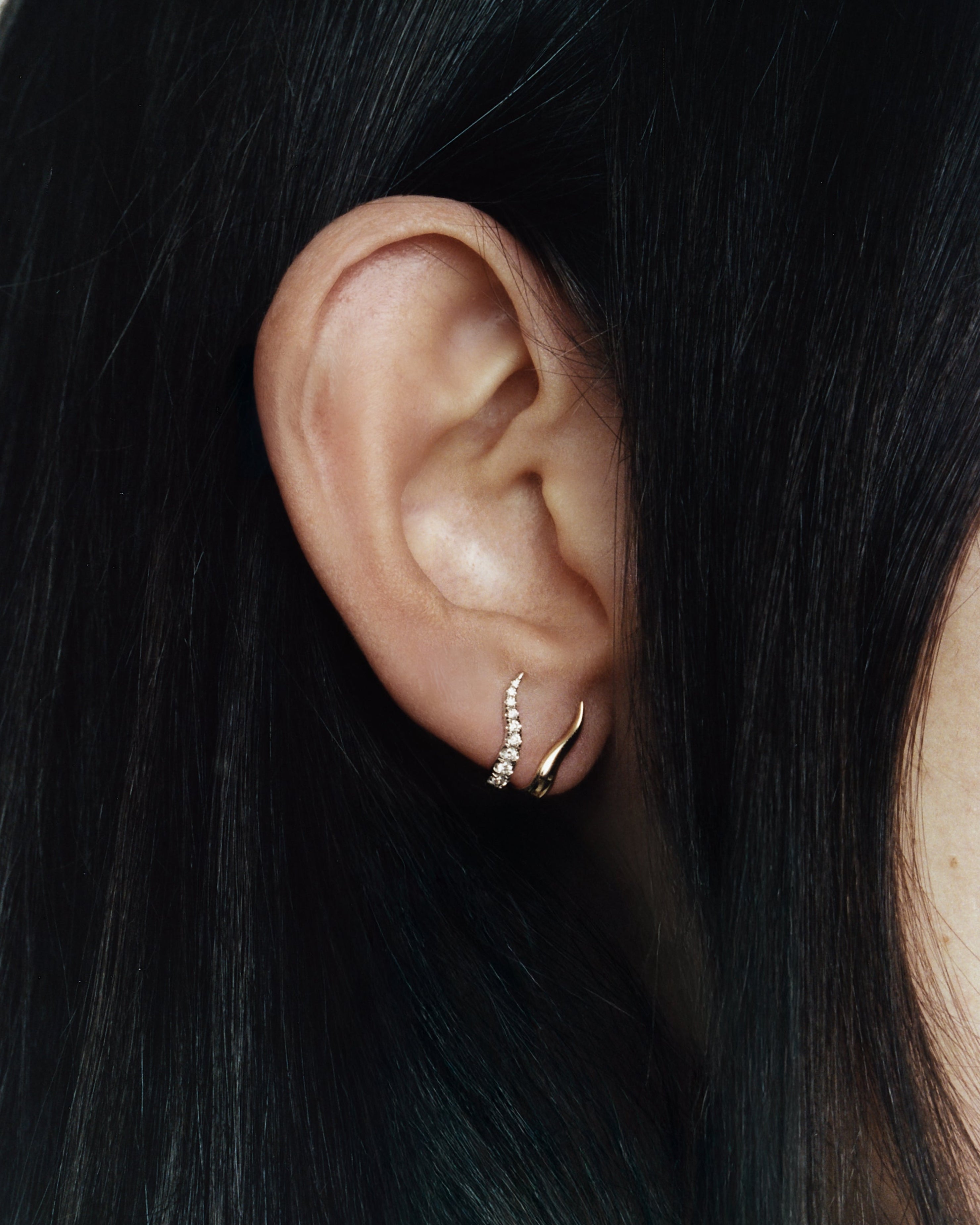 unique shaped gold earring with diamond pave
