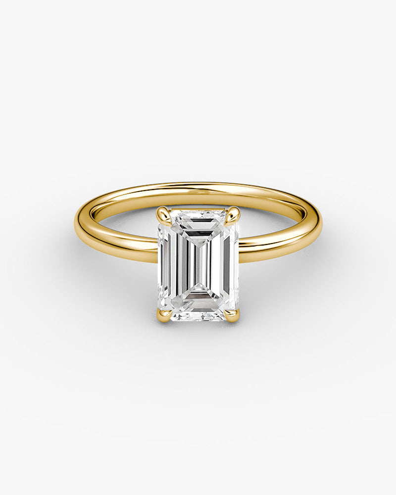 yellow gold engagement ring with an emerald cut diamond