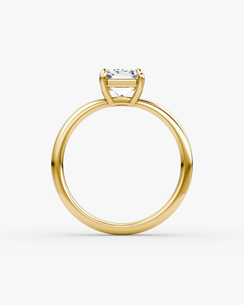 yellow gold engagement ring with an emerald cut diamond