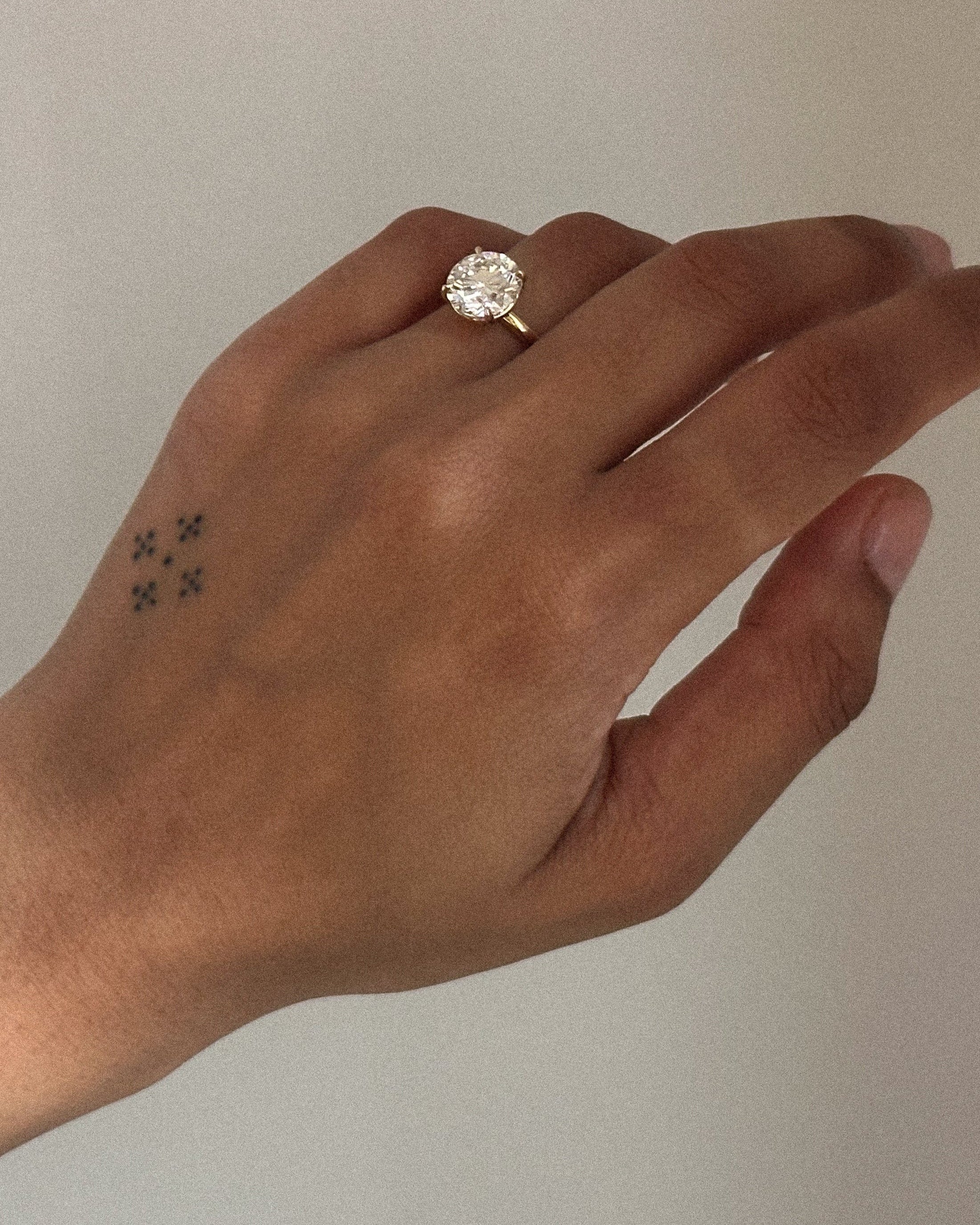 yellow gold engagement ring with round brilliant diamond