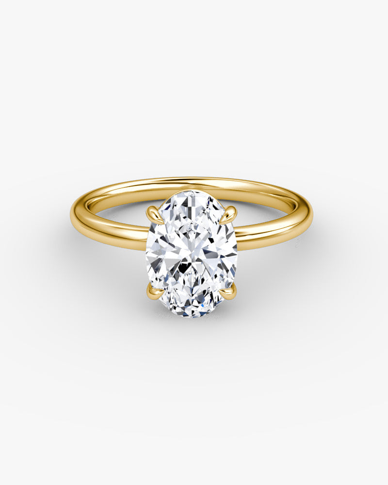 yellow gold engagement ring with an oval cut diamond