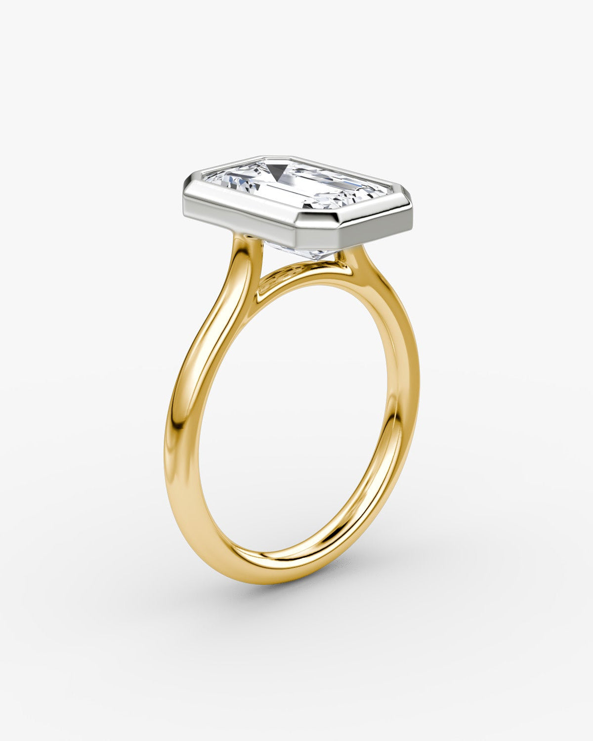 yellow gold band with a large emerald-cut bezel set diamond in a platinum setting