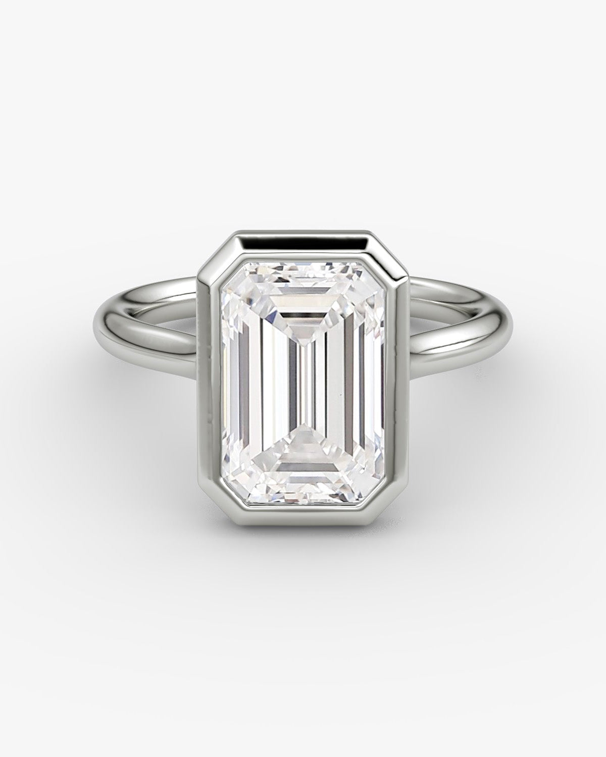 white gold ring with a large emerald-cut bezel set diamond 