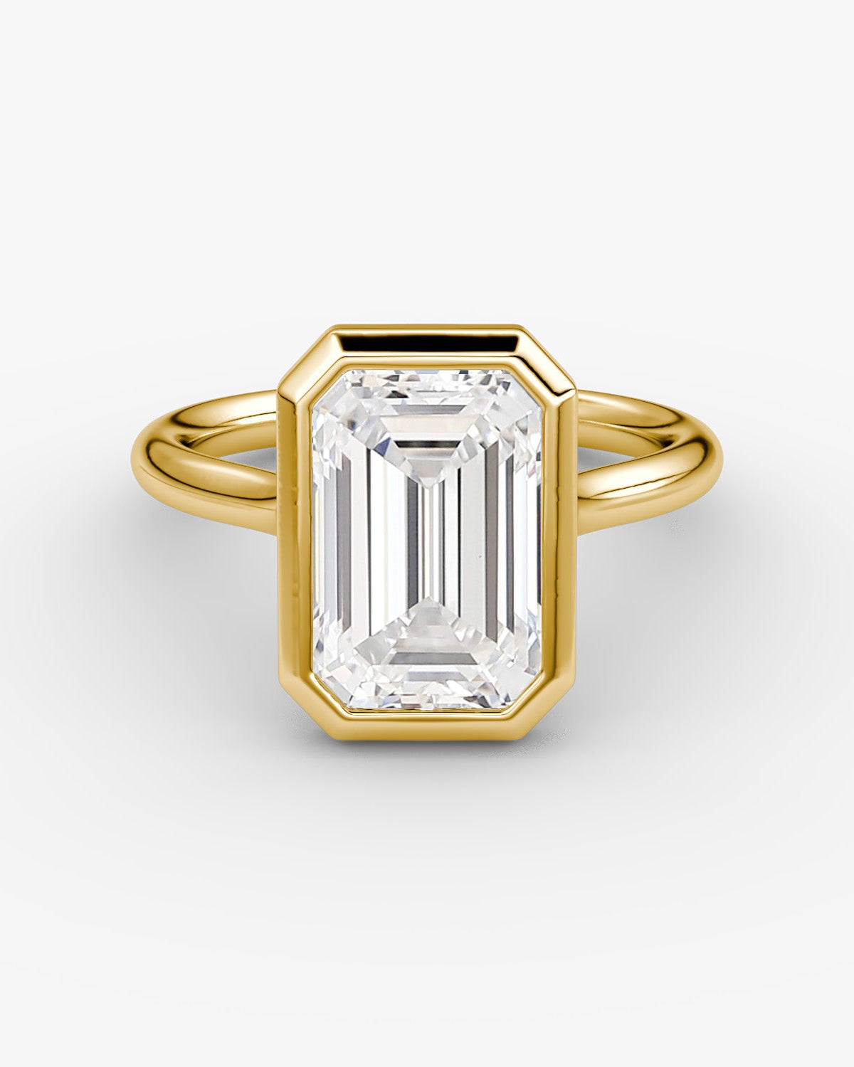 yellow gold ring with a large emerald-cut bezel set diamond 
