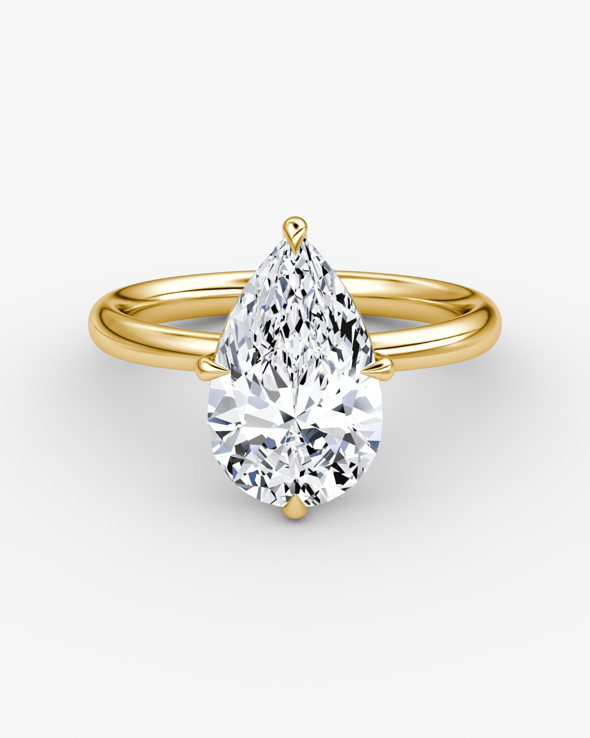 yellow gold engagement ring with a pear-shaped diamond