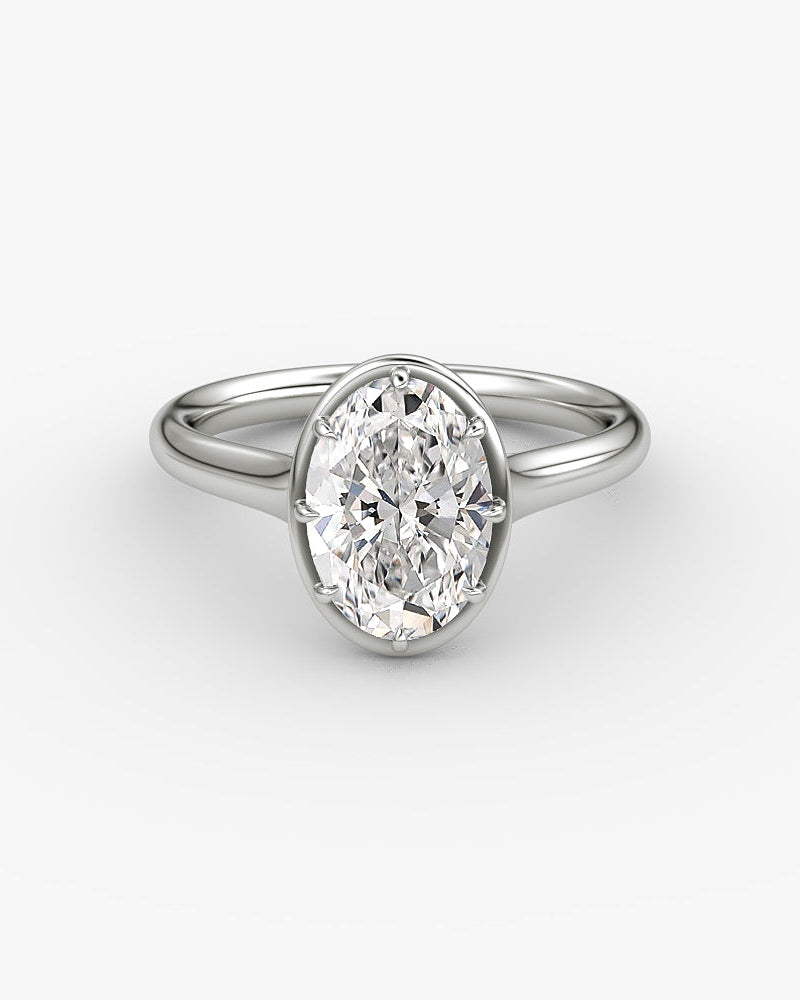 White gold engagement ring with an oval diamond in a Georgian cut down inspired setting