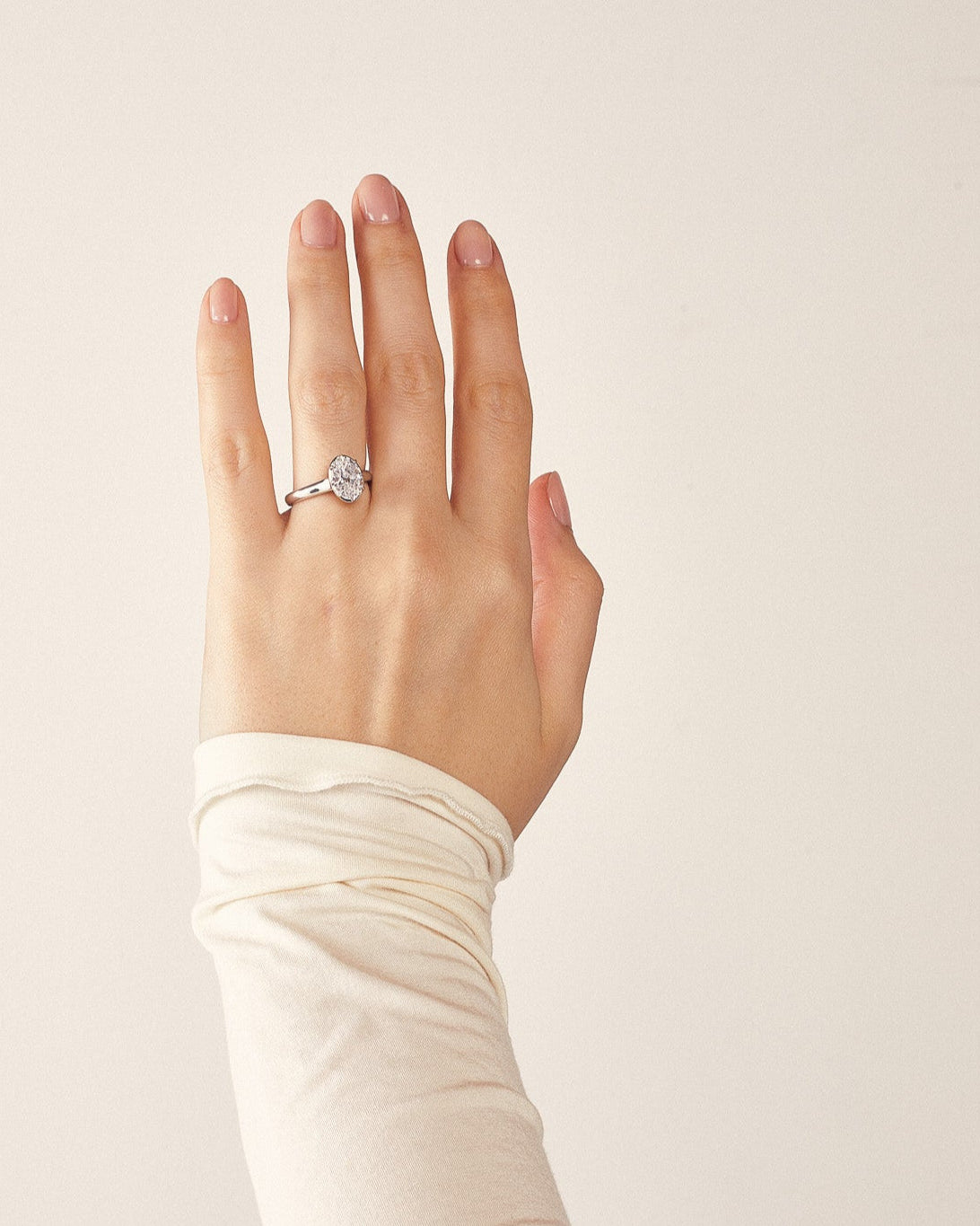 White gold engagement ring with an oval diamond in a Georgian cut down inspired setting