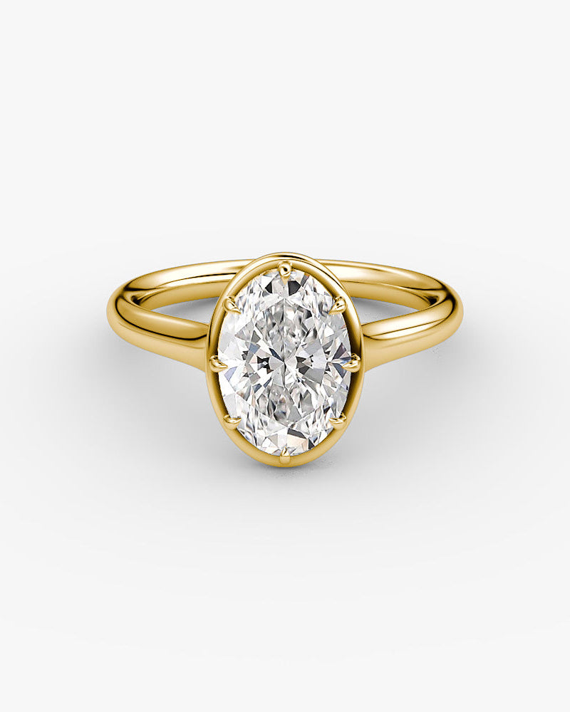 yellow gold engagement ring with an oval diamond in a Georgian cut down inspired setting