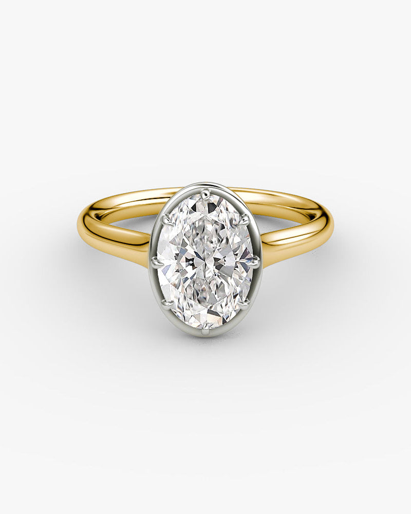 yellow gold engagement ring with an oval diamond in a Georgian cut down platinum inspired setting