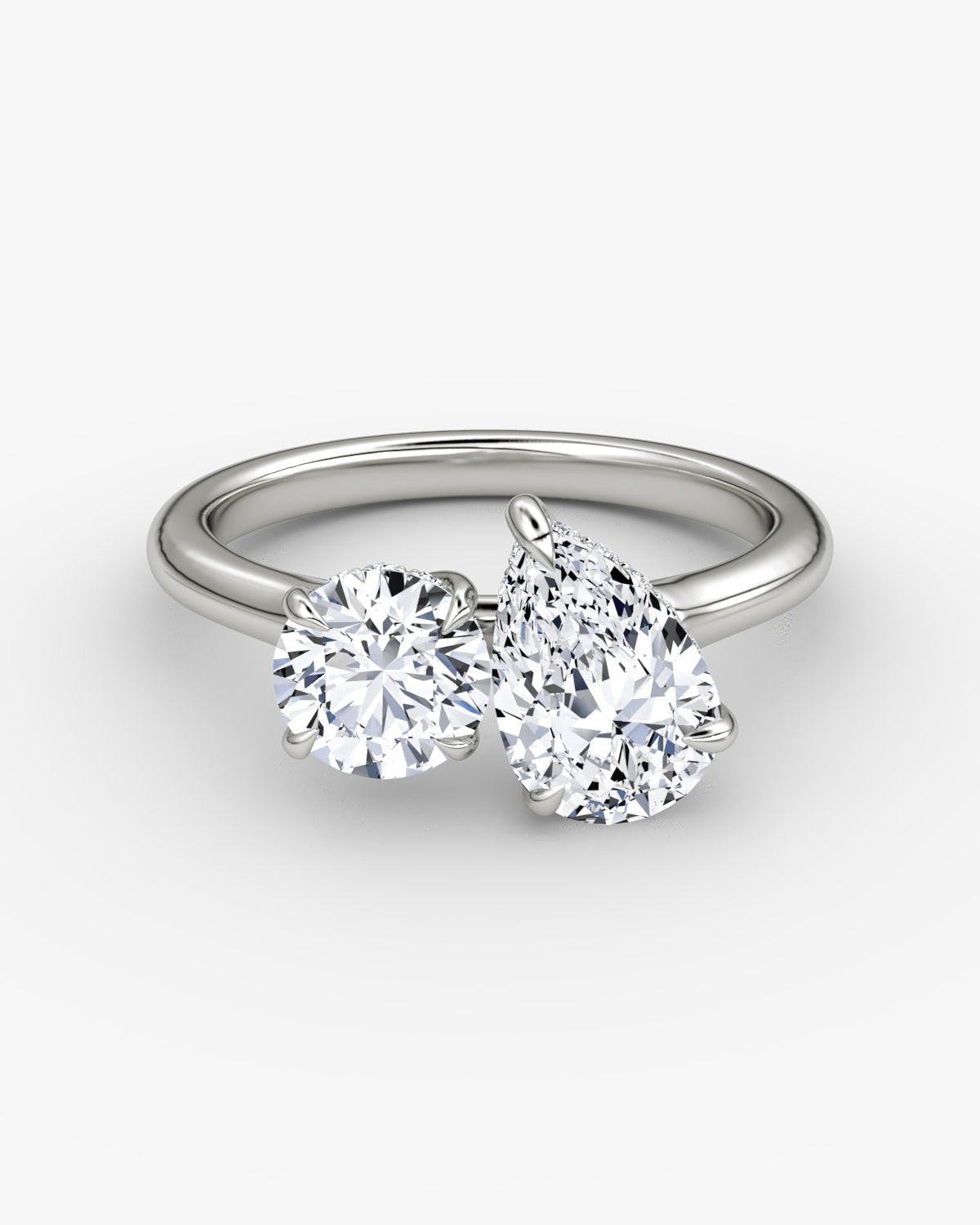 white gold two stone engagement ring with round and pear diamond