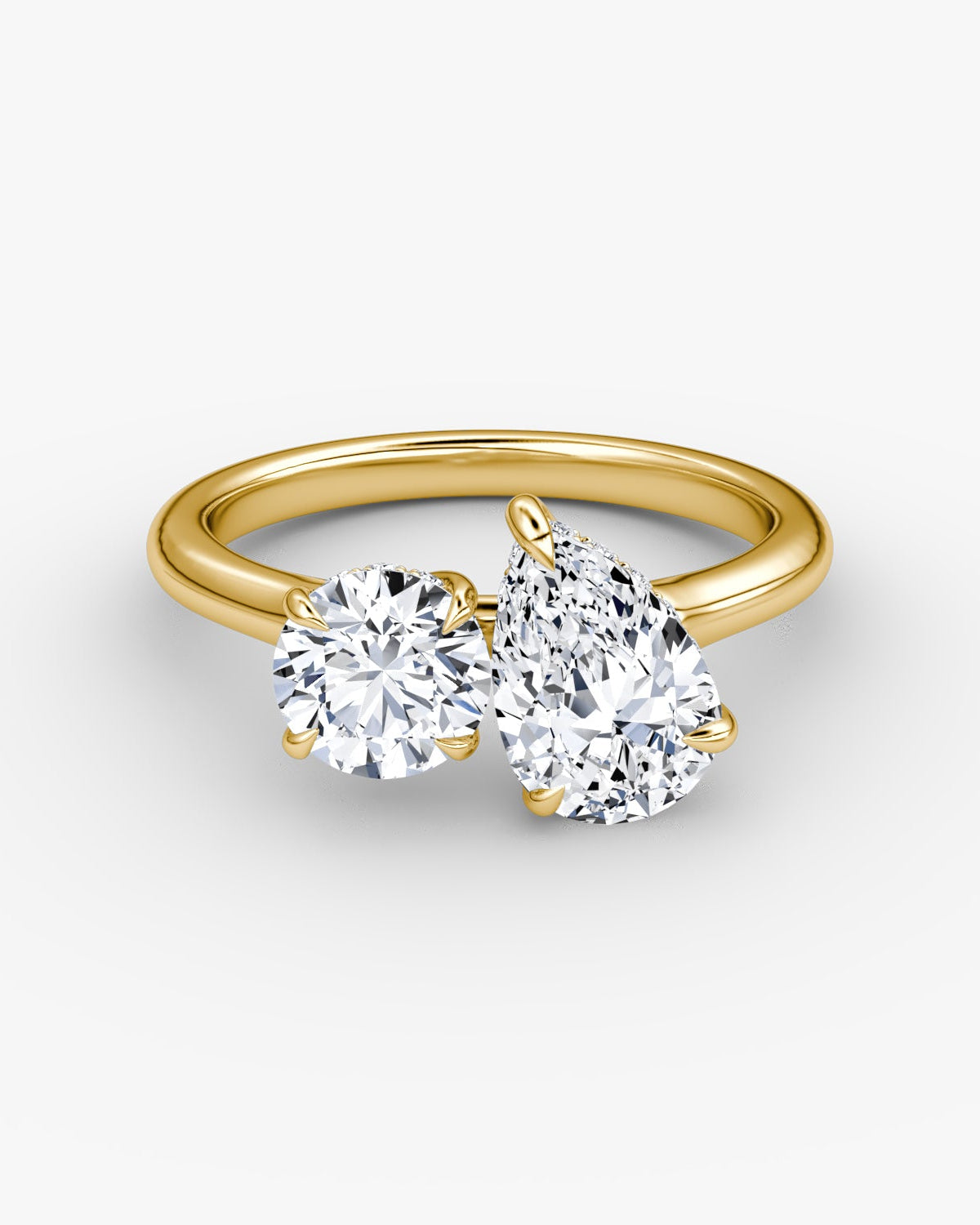 yellow gold two stone engagement ring with round and pear diamond