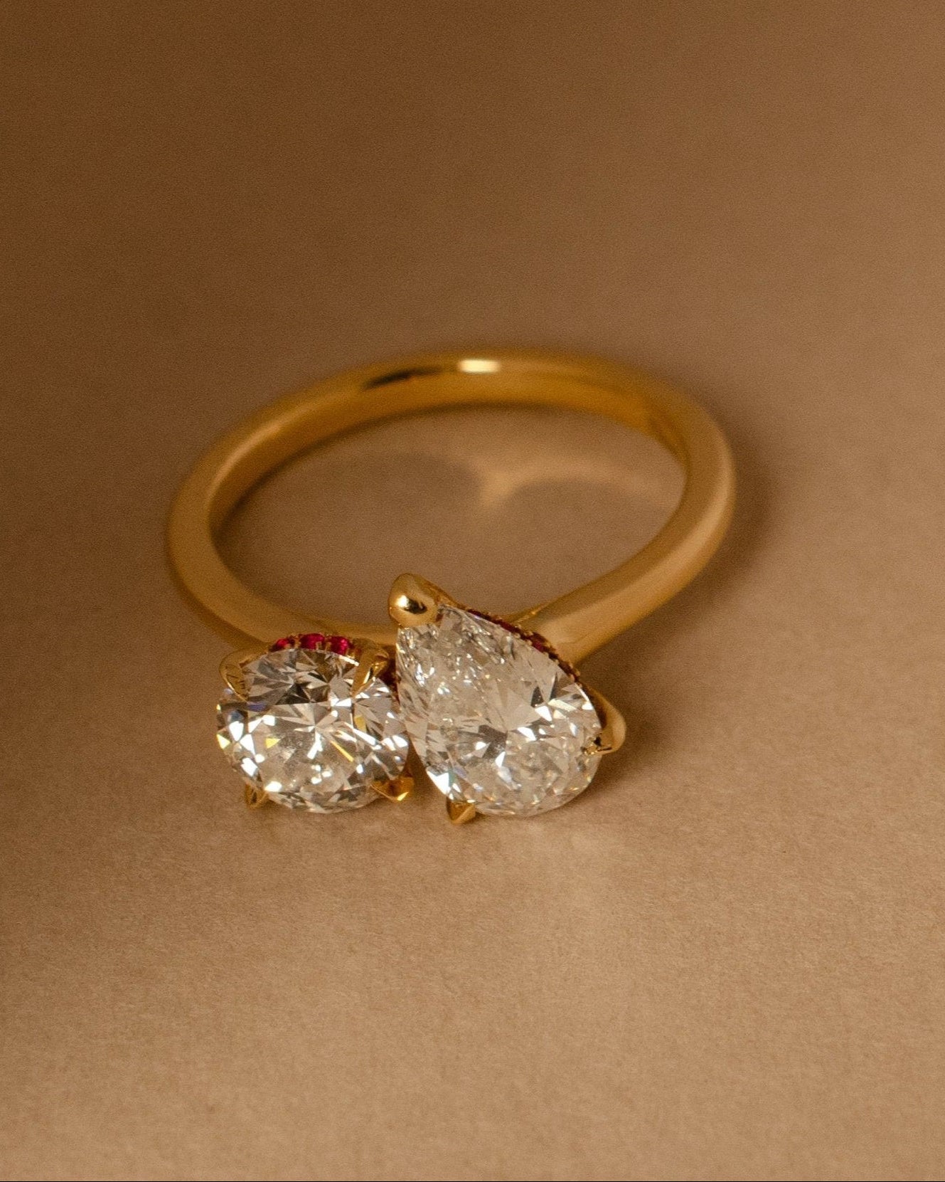 yellow gold two stone engagement ring with round and pear diamond