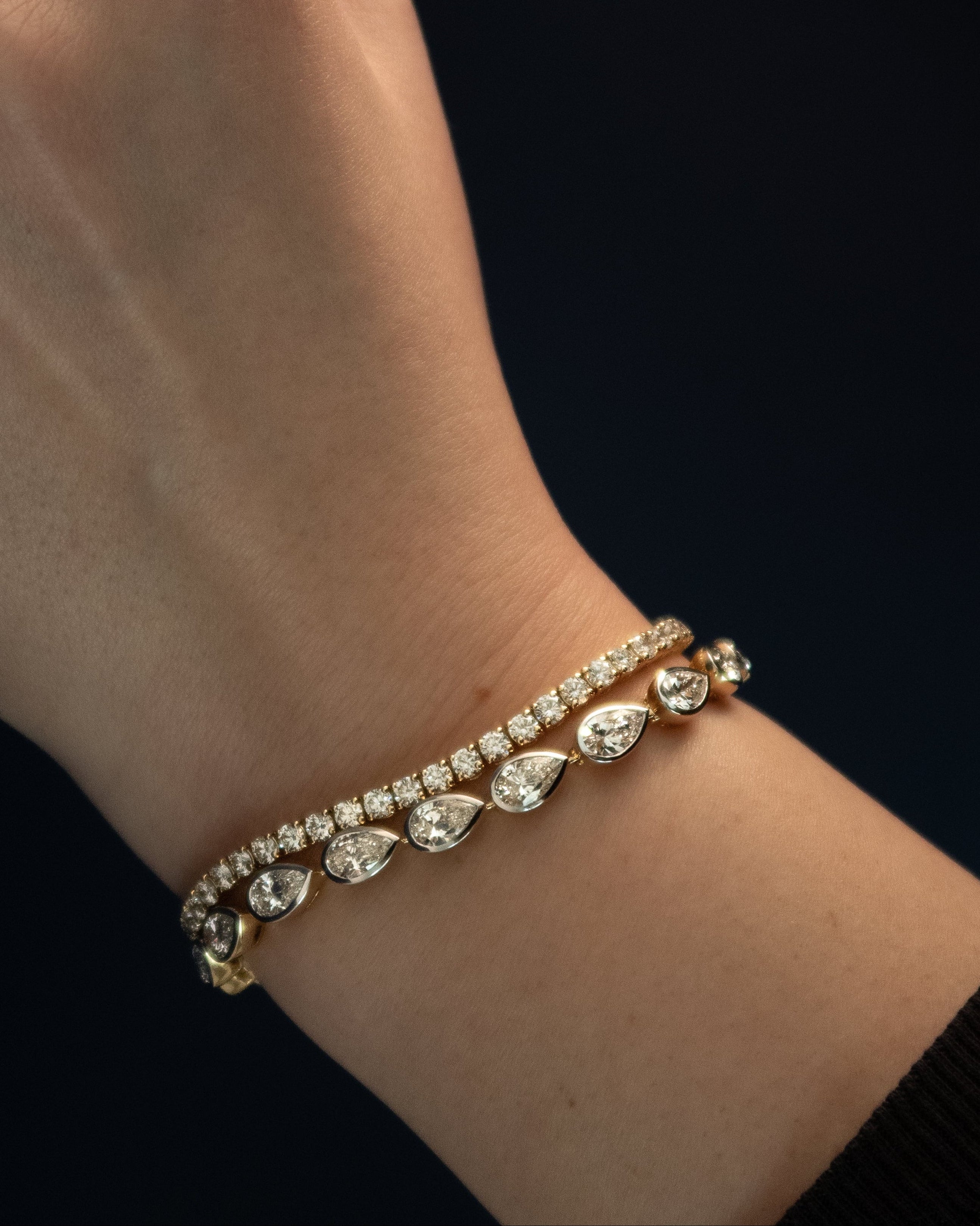 gold tennis bracelet with pear shaped diamonds
