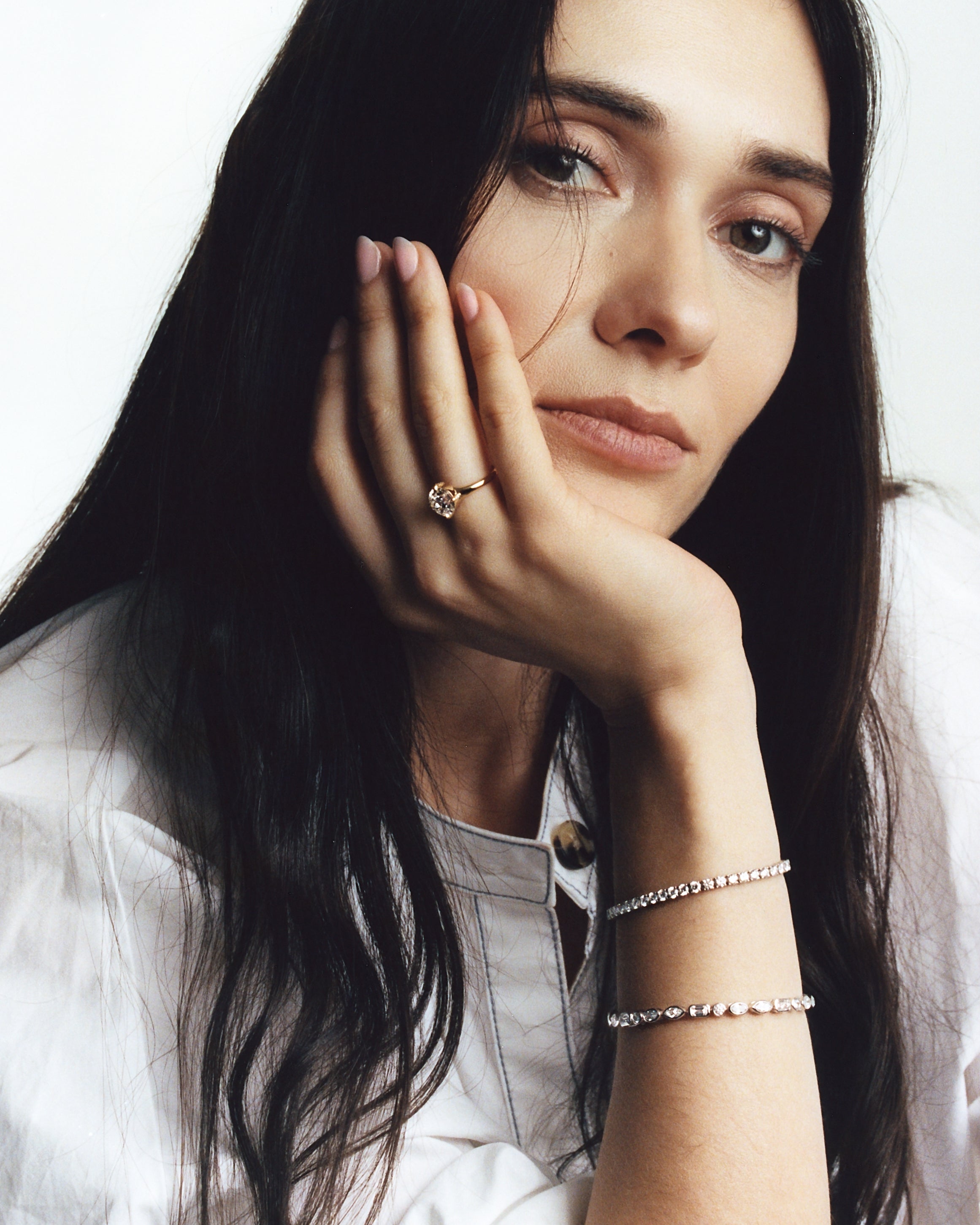 model poses with 4 prong white gold tennis bracelet