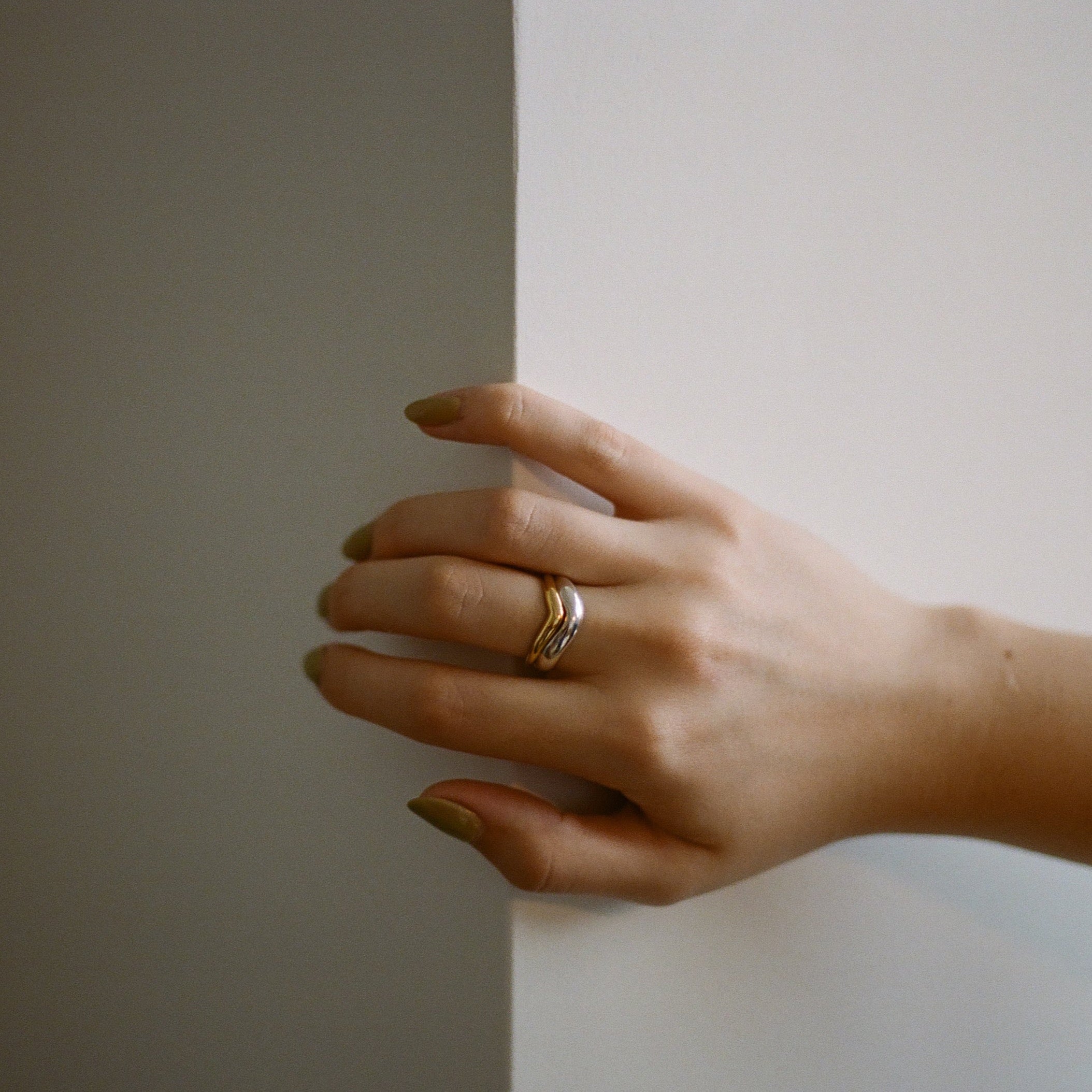 gold and silver ring on hand 